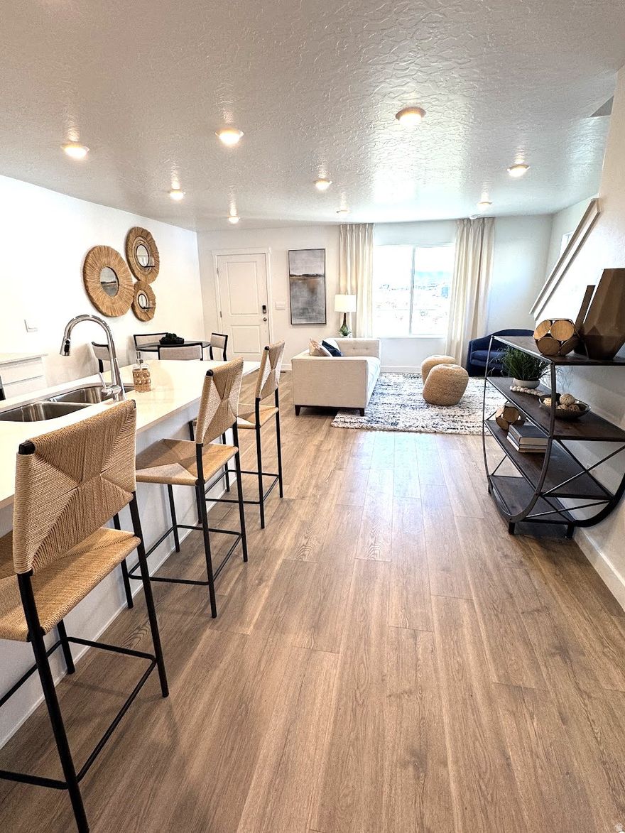 BRAND NEW, NEVER LIVED-IN, TOWNHOME FOR RENT! There's no better location than NE Lehi with close proximity to Silicon Slopes, Outlets @ Traverse Mtn, schools, grocery stores, restaurants, the I-15, and future LDS Lehi Temple site. You will fall in love with this new community called Inverness...where the views come standard and the amenities are plentiful. This particular home faces green space, the community pavilion, playground, pickleball courts, clubhouse, pool, and splash pad. There are walking trails throughout as well as access to hiking and biking trails.    Enjoy mountain views, guest parking, quartz countertops, stainless steel appliances (gas stove), laminate flooring, new washer/dryer/refrigerator, smart home package, keyless entry, neutral colors...and so much more. 2" faux wood blinds were installed for you. All 3 bedrooms are upstairs and there's a 1/2 bath on the main level. Storage space can be found in the crawl space, under steps, and garage. ***((Photos are of finished homes of the same floor plan and may contain upgrades, decor, or furnishings not included in this property. Photos without decor/furniture are of the actual property.))**  Lease will go until 7/31/2026 with first right to renew 60 days prior to expiration. Property manager has chronic allergies so smoking, pets, and ESAs are prohibited. Full application, background check, credit check, etc. required.   Thank you and WELCOME HOME!