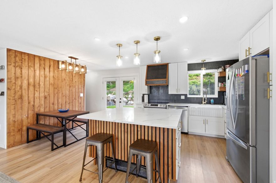 **No showings until after the Open House on May 2** Completely remodeled and move-in ready, this Riverdale home offers 5 bedrooms, 3 bathrooms, and over 2,200 square feet of thoughtfully updated living space on a spacious 0.23-acre lot. The main level features a bright, open layout centered around a fully renovated kitchen with quartz countertops, custom cabinetry, stylish finishes, and a large island designed for gathering, all flowing seamlessly into the inviting living area with a cozy fireplace and built-in shelving. Throughout the home you'll find custom touches that set it apart, including hidden Murphy beds and flexible spaces perfect for guests, a home office, or multi-use living. The lower level provides additional room to relax or entertain, while the backyard truly steals the show with a large deck, pergola seating area, terraced landscaping, and plenty of space for kids, play, and outdoor enjoyment. Major system updates add peace of mind, including a new A/C (2022), new sewer line (2023), new roof (2024), and new water heater (2025). Tucked on a quiet street with quick access to shopping, dining, parks, and freeway access, this home offers the perfect combination of location, upgrades, and lifestyle. Buyer and buyer's agent to verify all information.