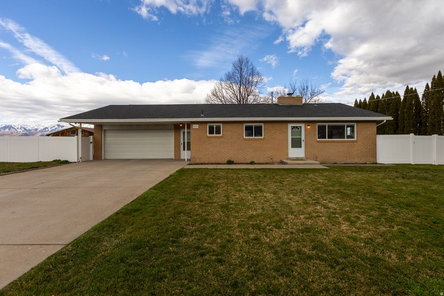 Attractively updated single-level home on a spacious 0.36-acre lot with stunning mountain views in desirable Nibley, Utah. This home features numerous upgrades including a newer roof (2021), furnace and smart thermostat (2022), central AC and condenser (2022), water heater (2023), and a brand-new shower and tub with updated plumbing (2026). Other interior improvements include flooring, carpet, paint, ceilings, trim, baseboards, and toilets, creating a fresh and modern feel throughout. The property also offers a 2-car attached garage, automatic sprinklers, mature trees, partial fencing, and an oversized storage shed/outbuilding, providing plenty of space for storage, gardening, or hobbies. Conveniently located near schools, parks, and everything Cache Valley has to offer.