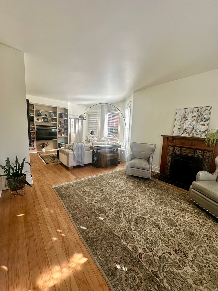 Rare Lower Avenues Oasis with Endless Flexibility!  Secluded on a quiet, one-way, tree-lined street, this exceptional residence blends historic elegance with modern, functional living. Cherished by the same family for 49 years and beautifully updated in 2026, the home features refinished original wood floors, fresh paint, new carpet, and updated plumbing and lighting fixtures and a new A/C unit. Period-correct traditional lighting beautifully bridges the home's classic character with its spacious 1990s expansion and three cozy fireplaces throughout.  Enter into this historic home emphasis on high Victorian-era high-ceilings and a very spacious living room with plenty of natural light through the picture and bay windows.  A beautiful formal dining room is adjacent to the kitchen where you can step in the backyard featuring a curated, grass-free botanical oasis where tiered patios wind through mature trees and lush perennial beds, all set around entertaining and the stream.  Designed for premium family living, the upstairs floor plan features three dedicated bedrooms with large closets, plus an incredible bonus space: The showstopping, architect-designed primary sanctuary is an absolute retreat, complete with soaring vaulted ceilings, a private fireplace, and a patio overlooking the beautiful backyard where you can watch hummingbirds and relax to your personal recirculating stream.  The upper floor Bonus Room: Currently styled as a teen computer gaming room, this adaptable space is ready to become a nursery, craft studio, or crafters hub. Laundry is conveniently located upstairs with the bedrooms. The Main Level Flex Room: A large, additional main-floor room with its own fireplace-perfect as a fourth bedroom, executive home office, or informal family room.   Enjoy unmatched convenience just half a block from an elementary school and within easy walking distance to the University of Utah campus. You are minutes from downtown Salt Lake City, prestigious medical hubs (Huntsman, U of U, LDS, and Common Spirit hospitals), and just 20 minutes from the SLC International Airport.