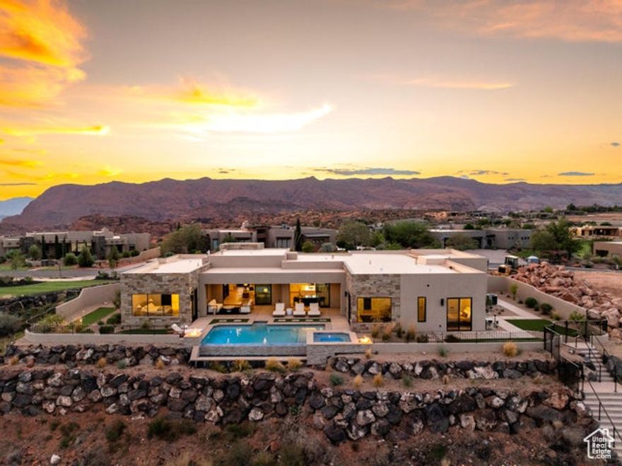 Experience refined desert living in this stunning custom home located in the highly sought-after Ledges subdivision. Showcasing breathtaking red rock views of Snow Canyon and a prime position along the golf course, this residence offers the perfect balance of luxury, comfort, and lifestyle. Featuring 4 spacious bedrooms, 3.5 baths, and a dedicated office, the home is thoughtfully designed with high-end finishes and exceptional attention to detail. The gourmet kitchen is complete with a large island and a butler's pantry, creating both functionality and elegance. Step outside to your private backyard oasis, where an infinity-edge pool, two fire features, and a jacuzzi set the stage for relaxation and entertaining. Home sold fully furnished!  A putting green adds a playful touch, while expansive outdoor living spaces are perfectly positioned to capture the dramatic canyon backdrop.  The 3-car garage provides ample storage, making this home as practical as it is beautiful. Whether enjoying quiet evenings or hosting gatherings, this home embodies the best of St. George luxury living.