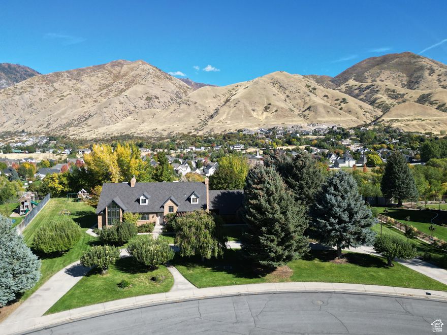 Must-see-one of the best lots in Mapleton, overlooking the stream. This high-quality, two-story home has been partially updated. The heating system includes both hot-water radiant and forced-air heat, along with central air conditioning. The great room features a two-story ceiling with exposed beams, custom moldings, and a cherry-wood spiral staircase leading to the second-floor library.  The kitchen has been completely remodeled, and the home includes new flooring and interior paint, refinished wood trim, 50-year architectural shingles, updated heating and air conditioning, a new radon mitigation system, a new mini-split system for the second-level library, and refinished decks.  The rear yard includes a detached deck, stairs leading to a lower landing deck, and a climbing wall overlooking Hobble Creek. The large yard is beautifully landscaped. Additional features include a central vacuum system and a basement safe/vault with a Fort Knox vault door and night lighting.