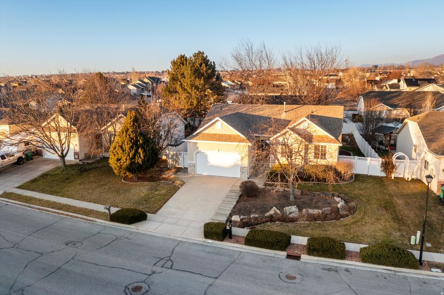 Welcome home to this beautiful Layton property with a newly finished basement and room to grow. The basement offers flexibility to easily add an additional bedroom and bathroom, also plumbed for an additional washer and dryer. Inside, you'll love the vaulted ceilings and the open, inviting feel that make this home live large and feel bright. The  built-in salon space that can remain or be removed to suit your needs. Plus an extra-wide garage features built-in shelving and abundant storage. Step outside to a private backyard with mature shade trees and four raised garden beds, ideal for relaxing, entertaining, or growing your own produce. Minutes to Hill AFB, easy access to Salt Lake, and local shopping centers.
