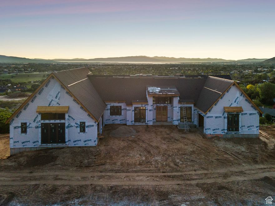 Come experience refined living in this newly constructed luxury home in Mapleton Estates, crafted with Parade of Homeslevel finishes and modern comfort throughout. Sitting on a .56-acre lot along the Mapleton bench, this 7,100 square foot home is designed for elevated living, world class comfort, and offers panoramic views of Utah Lake, the valley, and surrounding mountains. Nearing completion. Exterior details include natural copper gutters, Hardie Board siding, and natural stone-a timeless, low-maintenance mix with minimal yard upkeep. Inside, enjoy main floor living and large open spaces filled with light. The main level features a spacious owner's suite with a spa-style bath, soaking tub, and walk-in closet. Gourmet kitchen includes custom cabinetry, a butler's pantry, and quality appliances, beautiful, and built to last. Designed for both comfort and play! The home includes a private gym, sauna, indoor cold plunge, pool, and a built-in spa on the deck. HIGHLIGHT - A regulation-size indoor pickleball court that also doubles as a full-size half-court for basketball-an incredible year-round amenity. Energy efficiency is top-tier with ZIP System exterior sheathing, AdvanTech flooring system (waterproof and squeak free), dual-stage variable speed HVAC with zoning capabilities, R-50 attic insulation, and R-24 BIBS walls. Quiet, comfortable, and efficient. Includes a 1-year builder warranty. Minutes from schools, recreation, and everything Utah Valley has to offer!
