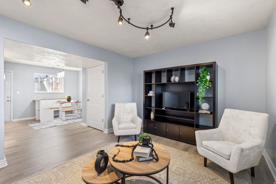 Just reduced $5K! *3D Tour* + *Open House 12/6 Saturday from 12-2 PM* + *1% Preferred Lender Incentive Available (Closing Costs/Rate Buy Down)* Beautifully updated & move-in ready in downtown Spanish Fork! Enjoy maintenance-free living with your fully-fenced backyard & landscaping handled by HOA. Prime walkable location near dining, shopping & entertainment. New AC & furnace (2022), roof replaced (2019, HOA covered). All stainless-steel appliances (2024) + washer & dryer included. Playground & picnic areas perfect for relaxing in this quiet well-kept community. Modern elegance with new LVP flooring, new carpet, freshly painted rooms, and ceiling fans (2023). Enjoy the open-concept layout with 3 bedrooms and 1.5 bathrooms, featuring vaulted ceilings in the primary bedroom, abundant storage & walkout basement for easy indoor/outdoor living. 2 reserved parking spots included: 1 covered/1 uncovered. This home offers a lifestyle of convenience. Right across the street from: Costco, Macey's Grocery, Restaurants, City North Park & Splash Pad, and nearby Walmart, Target, Cinemark Theater, VASA Fitness, Spanish Fork Canyon. Quick freeway access & 15 minutes from BYU/UVU. Come see why this is one of Spanish Fork's best values! - Buyer/Buyer's Agent to verify all. Square footage figures are provided as a courtesy estimate only and were obtained from county records. Buyer is advised to obtain an independent measurement.