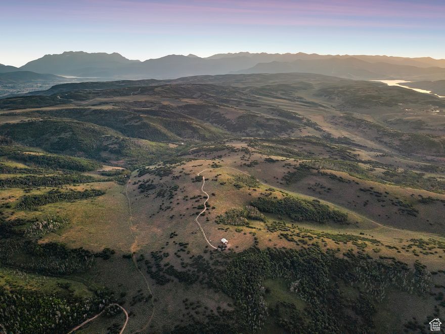 Escape to 163 acres of pristine wilderness with breathtaking panoramic 360 views in Woodland. You will find pure serenity on the massive wrap-around deck featuring unobstructed views of the Uinta and Wasatch Mountains, including Mount Timpanogos. This spacious log cabin is offered fully furnished and features an unfinished basement providing plenty of room to expand. Enjoy off-grid independence with a private well, cozy wood fireplace, propane appliances, and a generator. Extensive hiking and cross country skiing are right outside your door. This unique retreat is forever protected by a Utah Open Lands Conservation Easement. Do not miss this once-in-a-generation opportunity. https://youtu.be/adMy39lUDkM