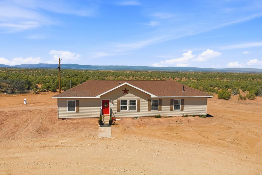 Discover country living at its sweetest in this darling manufactured home that truly feels like a stickbuilt residence, nestled in the rolling hill country of Duchesne County. Set on 6.28 acres-with an additional 6.3acre parcel included in the sale-this property offers space, privacy, and endless possibilities. The home has been thoughtfully remodeled with a new kitchen, updated countertops and backsplash, fresh flooring, and interior paint, creating a warm and inviting interior that's movein ready. Step outside to the spacious back patio/deck, perfect for gatherings, BBQs, and taking in the peaceful rural setting. Ready to farmstead? This property delivers with a huge shop, ample room for equipment, and beautifully groomed land ideal for animals, gardening, or expanding your homestead vision. Whether you're seeking a fulltime residence or a country retreat, this property offers comfort, acreage, and opportunity in one Parcel No 00-0033-0001 6.3 Acres is included in the sale. Lot 21 of Sundance West Unit D;sec 16 T2s R4w Usm