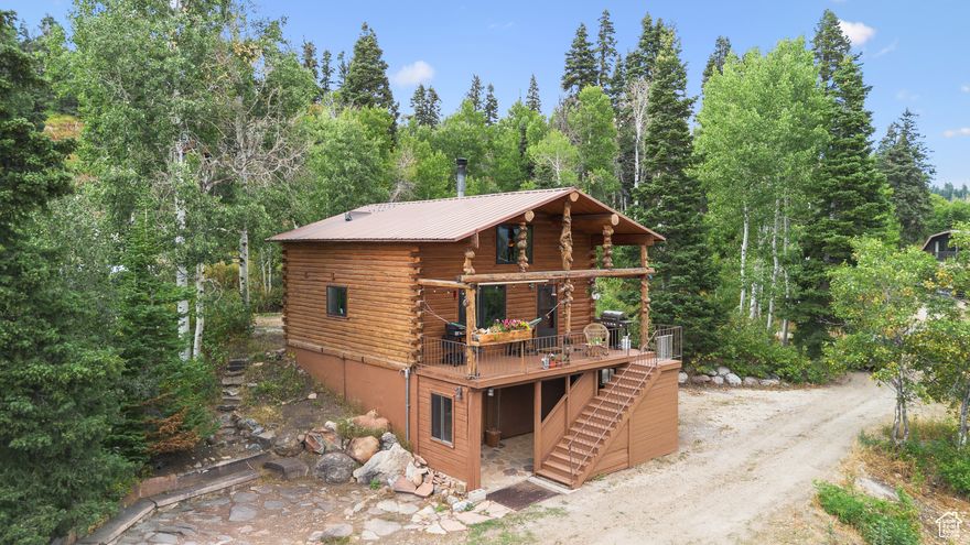Adorable and well built log cabin in Tollgate Canyon! A mountain paradise, move-in ready!! Great home or mountain retreat. Turn key and fully furnished. Two car garage and TWO flat driveways. Unique home with mountain charm and unobstructed Uinta views with morning sun on the covered deck. Finished apartment basement has bed, bath, laundry and mudroom. Loft makes a great third bedroom or office space. Open main floor with wood stove. Detached garage has its own power system for your tools along with another wood stove for heating. Covered wood storage keeps the cords of wood dry all winter for you. On Plow route!  With the right offer will come fully furnished along with a Kubota L5030 Tractor with front Snow Blower and (2) 2022 Polaris backcountry Snowmobiles