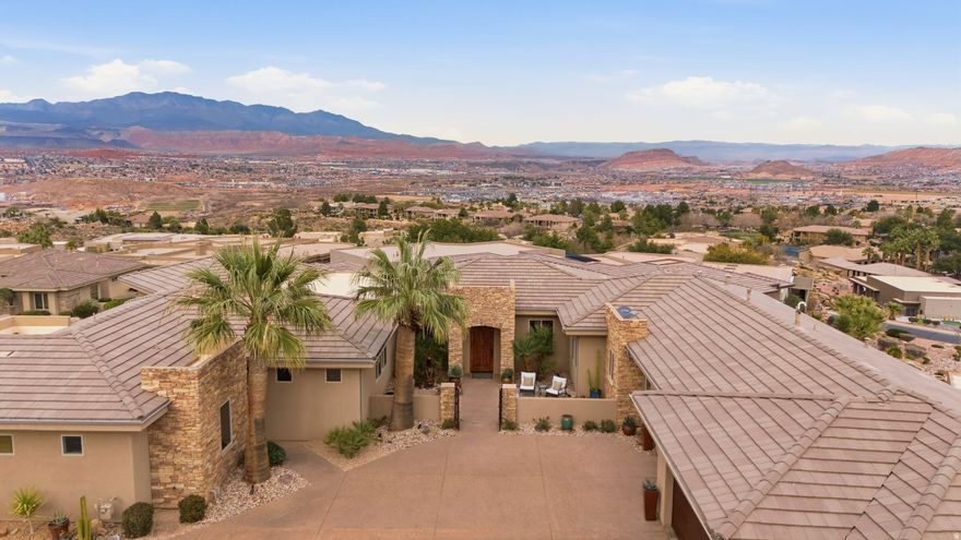 Set high above the valley, this home captures breathtaking panoramic views of red rock landscapes, city lights, and Pine Valley Mountain rising in the distance. From sunrise to sunset, the scenery unfolds from nearly every space-including the pool, primary suite, and main living areas. The depth and scale of these views are far more dramatic than photos can convey. It's a perspective that truly must be experienced to be fully appreciated.  Equally remarkable is the privacy and tranquility of the setting. The backyard offers a rare retreat where expansive views stretch outward while no one is looking in. The peaceful surroundings are complemented by the soothing sounds of the brand-new pool and spa, creating an ideal setting for quiet evenings or memorable gatherings.  Located within the prestigious guard-gated Stone Cliff community, this residence lives up to its Paragon address. Positioned on a premium lot above the valley floor, the home was thoughtfully designed to capture natural light and frame the surrounding scenery.  Inside, clean architectural lines and soaring ceilings create a bright, open atmosphere. The great room, kitchen, and pool terrace flow seamlessly together, creating an effortless indoor-outdoor lifestyle ideal for entertaining or relaxing in complete privacy. The well-designed floor plan features four bedrooms, each with its own ensuite bath, including an attached casita ideal for guests, multigenerational living, or a private office.  Stone Cliff residents enjoy exceptional amenities including 24-hour security, a clubhouse, fitness center, lap and recreation pools, cabanas, pickleball and tennis courts, and on-site community management.  Just minutes from Tuacahn, world-class hiking, fine dining, downtown St. George, and the airport-with Zion National Park less than an hour away.