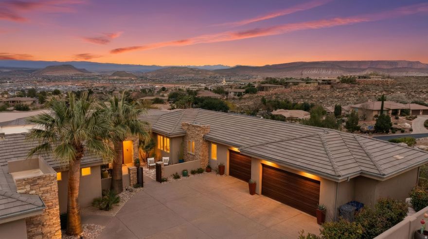 One of the most captivating view homes in Stone Cliff, where panoramic red rock, city, and Pine Valley Mountain views unfold from nearly every space, something that truly must be experienced in person. From sunrise to sunset, the scenery becomes part of daily living, visible from the pool, primary suite, and main living areas, creating a seamless connection to the surrounding landscape. The depth, scale, and emotion of these views extend far beyond what photos can capture. Enjoy swimming in the newly updated pool or relaxing in the spa while taking in both the morning light and evening glow, an exceptional feature that brings the beauty of the setting into every moment. The backyard offers a rare sense of privacy and tranquility, where expansive vistas stretch outward while no one is looking in. The pool and spa create a true resort-style environment, ideal for quiet evenings or unforgettable gatherings. Located within the prestigious guard-gated Stone Cliff community, this residence lives up to its Paragon address, positioned on a premium lot above the valley floor and thoughtfully designed to capture natural light and frame the surrounding scenery. Inside, clean architectural lines and soaring ceilings create a bright, open atmosphere. The great room, kitchen, and pool terrace flow effortlessly together, creating an indoor-outdoor lifestyle perfect for both entertaining and everyday living. The well-designed floor plan features four ensuite bedrooms, including an attached casita ideal for guests, multigenerational living, or a private office. Residents of Stone Cliff enjoy exceptional amenities including 24-hour security, a clubhouse, fitness center, lap and recreation pools, cabanas, pickleball and tennis courts, and on-site community management. Just minutes from Tuacahn, world-class hiking, fine dining, downtown St. George, and the airport, with Zion National Park nearby.