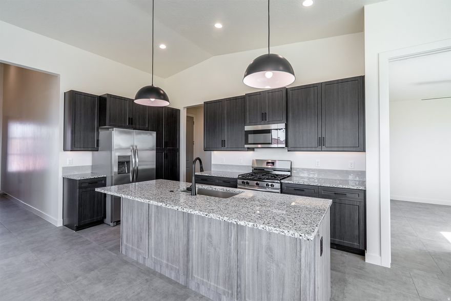 The Aurora - This well-designed 2-bedroom, 2-bath home offers modern living with an open-concept layout connecting the spacious great room and stylish kitchen. Features include thermofoil cabinetry, granite countertops, a single-bowl stainless steel undermount sink, and a Frigidaire stainless steel appliance package with electric range, microwave hood, dishwasher, and refrigerator. Interior finishes include two-tone paint, tile flooring in main living areas, carpet in bedrooms, can lighting throughout, and ceiling fans in the living room and bedrooms. Bathrooms feature Moen plumbing fixtures and custom tiled showers/tub surrounds. Additional highlights include a laundry room with sink cabinet, extended finished garage with 50-amp EV breaker and room for a workshop or toys, block walls, and backyard space. Community amenities include a pool, hot tub, pool house, pickleball court, playground, and RV parking.  Home must be under contract by January 15, 2026, to qualify at this pricing. Builder offers no upgrade costs all finishes and features shown are included as the builder's standard. Every detail comes upgraded, providing exceptional value with premium selections already built in.