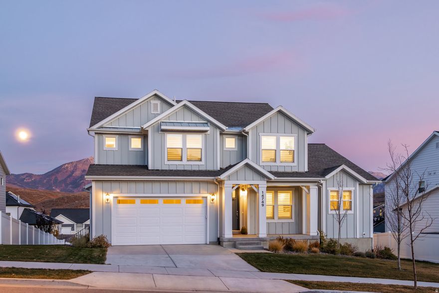 Imagine cuddling up with the moonlight spilling over Lone Peak, right outside your primary bedroom doors. From the moment you step onto your private balcony, it's clear this home was designed to capture both the beauty and serenity of Suncrest living. This sought-after Tessa floorplan offers a spacious main-level primary suite with a walkout balcony-making every morning feel like a mountain retreat. The ensuite features a large walk-in closet, double vanity, and standalone tub offering comfort and convenience in a beautifully balanced layout.  At the heart of the home, a gourmet kitchen awaits with double ovens, a generous island, and a walk-in pantry perfect for both quiet mornings and lively gatherings. Natural light pours through every corner, creating a warm and inviting flow between the dining, living, and outdoor spaces.  Upstairs, a bright and airy loft anchors three additional bedrooms, giving everyone their own space while still feeling connected to the main floor activity. Downstairs, the unfinished walkout basement with above-grade windows is brimming with potential, ideal for future expansion or even a separate unit.  Outside, the large, flat yard is finished with high-quality turf, offering a low-maintenance lifestyle and the perfect spot for kids, pets, or evening relaxation under Suncrest's starry skies.  Nestled in one of the most scenic and outdoor-centric communities along the Wasatch Front, this home blends thoughtful design, comfort, and everyday luxury where every moonrise feels like an invitation to stay a little longer.