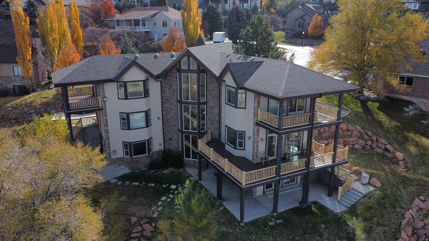 An extraordinary opportunity to own a stunning one-of-a-kind home in Draper's most prestigious and sought-after neighborhood. The property boasts panoramic views of the Salt Lake Valley from every level and from each of its 3 decks. 6 bedrooms and 3.5 bathrooms in a 4,600 square foot layout. The expansive master suite with luxurious master bath and two sided walk-in-closet leads onto its own private deck that frames city lights, mountain views, and valley sunsets.  Another deck is shared by two more bedrooms on the upper floor. The generously sized second floor laundry area has its own sink. On the main level the living area area opens onto a grand wrap-around deck. Easy entertaining across multiple levels using one of the two full  kitchens. A light-filled walkout basement adds two more bedrooms a large living area with full kitchen and a fully wired theater room. Every inch of the nearly 3/4 acre terraced yard provides a beautiful view. Three car attached garage with additional storage space. Accessible attic with more space for storage. Large circular driveway with plenty of room for extra parking. Located in the exclusive Draper Heights gated community.