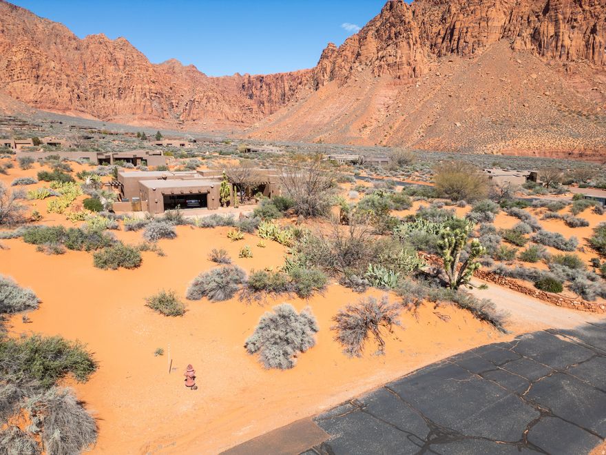 Breathtaking red rock views surround this spectacular desert retreat! The home features exposed wood beams, a beautiful custom wood ceiling, and colors and textures that complement the setting. A standout feature is the grand primary suite which boasts a separate sitting room with fireplace. The kitchen has newer cabinets and countertops. The expansive 1.62 acre lot provides exceptional privacy. Outdoor patio areas provide the perfect place to take in the incredible scenery and peaceful surroundings that make Kayenta one of Southern Utah's most unique and desirable communities. The tranquility, privacy, and breathtaking natural beauty of this home truly make it one-of-a-kind.