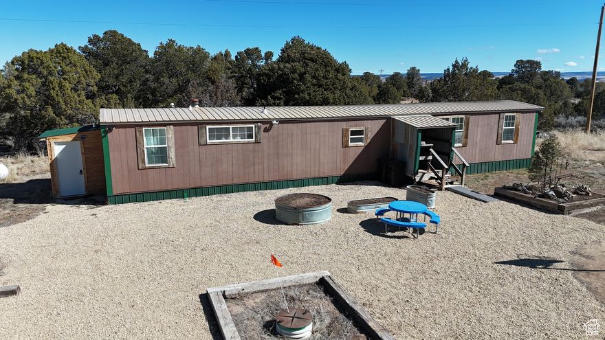 Looking for ultimate privacy and land close to town?  Look no further! This large, 7 acre property is nestled in the trees just off HWY 491.  Home has 2 bedrooms, and 1.5 bathrooms, and is move in ready!  Potential accessory dwelling unit that would be perfect to house guests or used as a rental.  And if you want to explore beyond your 7 acres, this home is close to several national parks and national monuments with endless opportunities for hiking, four wheeling, and exploring. The mobile home has many new updates, including new siding, roof, skirting, windows, floors, doors and trim, beautiful alder kitchen cabinets, countertops, refrigerator, and gas stove. Property includes a large, fully insulated 26x16 shop with power. This could make a great ADU with minimal effort. Plenty of space to house animals, grow gardens, and entertain.  The possibilities are endless! Other outdoor amenities include a rustic log cabin/carport, a well house, 2 RV hookups, a cement septic tank and new leach field, a 2nd leach field for grey water, new freezeless faucet, and propane tank. Fiber internet connected and ready for work from home!  All information is deemed reliable, but buyer to verify all.