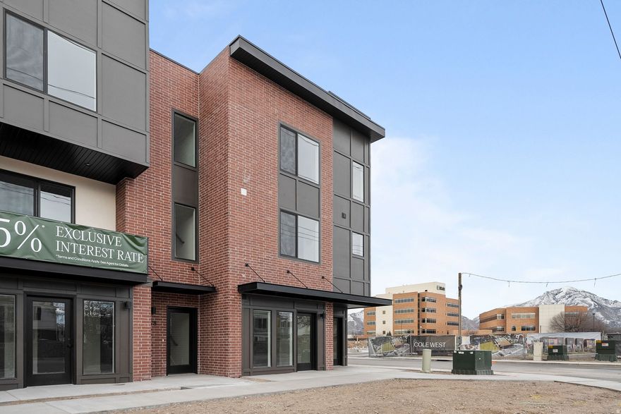 Expected finish mid-May - Live, work, and thrive at theMONROE with this versatile Live/Work townhome designed for modern urban living. Located in the heart of South Salt Lake, this unique residence offers a dedicated ground-level flex space-perfect for a home office, studio, or small business-paired with stylish multi-level living above. The thoughtfully designed layout features 3 bedrooms, 3.5 bathrooms, and a 2-car garage, with an open-concept main living area that seamlessly connects the kitchen, dining, and living spaces. Large windows and a private balcony bring in natural light, while contemporary finishes including quartz countertops, sleek cabinetry, and modern lighting create a clean, elevated aesthetic. Upstairs, the primary suite offers a private retreat with well-appointed bath and ample storage, while additional bedrooms provide flexibility for guests or work-from-home needs. The Live/Work design adds unmatched functionality, ideal for entrepreneurs or those seeking a flexible lifestyle. Enjoy low-maintenance living with close proximity to downtown Salt Lake City, dining, shopping, and community amenities including a pickleball court and green space. TheMONROE Live/Work units offer a rare opportunity to blend business and home in one dynamic space. Photos of same floorplan but different unit.