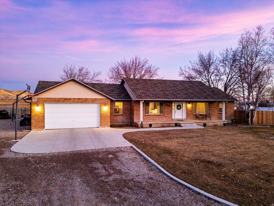 This impeccably renovated modern farmhouse blends open space with thoughtful, functional design.  Set on a private 1-acre lot in a quiet, established neighborhood with NO rear neighbors, this property is a professional's and hobbyist's dream, featuring a detached climate-controlled office and a 30x50 insulated shop.  Inside the home, every space is designed for real life and real comfort-from the custom kitchen and inviting gathering space to the cozy library with wood-burning stove. Six spacious bedrooms, beautiful bathrooms, abundant storage, and intentional details throughout make everyday living cozy and effortless.  Outside, enjoy sunrise views, mature trees, garden spaces, a chicken coop, firepit, and room for animals. This homesteading opportunity is modern living with country soul - - move-in ready and truly one of a kind.