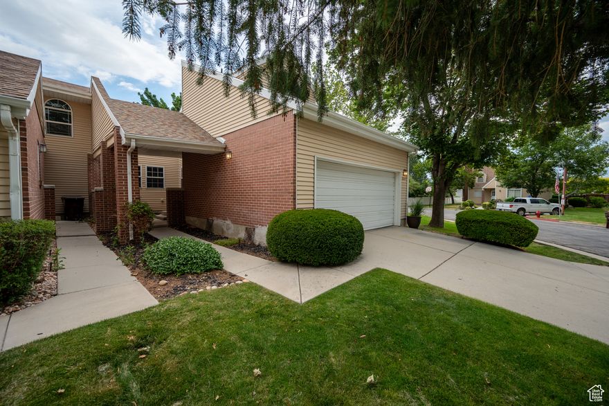 This beautifully cared-for end-unit townhome-style condo feels like a little pocket of calm tucked inside a well-kept, peaceful community. From the moment you arrive, the charming front courtyard sets the tone-welcoming, private, and just right for potted plants or a cozy entry moment.  Inside, the home feels bright, clean, and effortlessly comfortable. The open-concept living space flows naturally, making it easy to relax or gather with friends. With no neighbors above or below, it offers the privacy and feel of a single-family home. Upstairs, the bedroom balcony is the perfect place to enjoy a quiet morning coffee or wind down at the end of the day, while the private fenced backyard gives you space for pets, gardening, or summer evenings outside. Major updates bring peace of mind, including a new roof in 2024 and a new washer and dryer (2023)-both included. The attached two-car garage adds everyday convenience and extra storage. Location-wise, it's hard to beat. You're less than 10 minutes from the Maverik Center, with quick access to I-215, Redwood Road, and Bangerter Highway, making commuting, shopping, dining, and recreation easy. A large nearby park adds even more lifestyle appeal. If you've been searching for a low-maintenance, move-in-ready home that still feels personal and private, this one is special. Motivated seller 1-year home warranty included