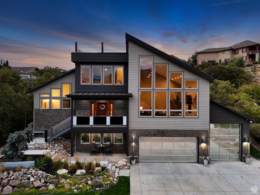 In a sea of sameness, some homes rise above the rest and stand out as truly unique. While sometimes "unique" can mean quirky, there are rare and exceptional homes where "unique" means something special, something extraordinary, and something truly premium. This is that home. Clean lines, bold architecture, and an impeccable layout elevate this home to a whole new tier. Set in SunCrest, the modern design meets the mountain and something about that juxtaposition just works. Step inside and you are immediately met with soaring 26-foot ceilings (you read that right), a floating steel staircase, and windows that frame views so striking they feel like artwork. The family room and kitchen define open concept living, made for gatherings that start with dinner and spill out to fireside chats on the patio. The kitchen itself keeps pace with granite counters, a gas range, and cabinetry that looks as sharp hosting a Saturday night cocktail soiree as it does a weeknight family dinner.  The primary suite is every bit a retreat, with 16-foot ceilings, two walk-in closets, and a spa bath featuring a separate jetted tub and shower. Upstairs, two more bedrooms and a full bath keep things flexible for family or friends. Downstairs, the ADU tells its own story. Two bedrooms, a bathroom, a full kitchen, and laundry give it everything it needs to stand on its own, with a private entry from the garage. Perfect for parents, kids, or guests who want their own space. And if you prefer it connected, a simple conversion brings it back into the main home.  And then there is the garage. The short version? Room for six or more cars. Over 1,200 square feet of radiant-heated space, built-in storage, and an oversized bay tall enough for your RV or boat. Call it a garage, but it is more like a showroom for whatever you roll in.  When it is time to get outside, you will not run out of options. Walk to the clubhouse for a workout or HOA activity, hike or bike the nearby trails, watch the sun drop behind the valley from your rooftop deck, unwind on the covered patio, or circle up around the built-in firepit. Fresh air, endless skies, and a home that stands apart. Rise above the rest of the market, get beyond the greige-ificiation of today's market, and live somewhere extraordinary.