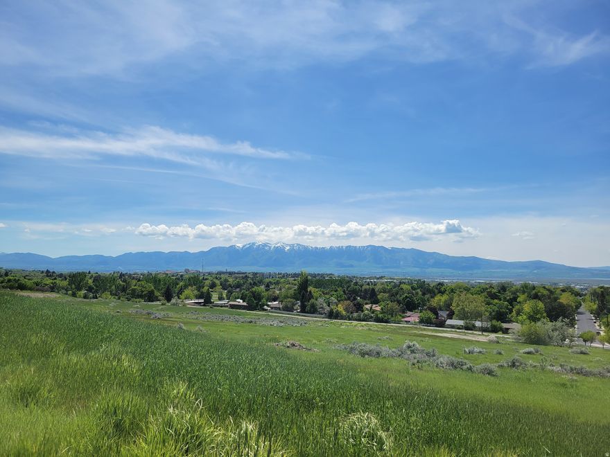 This generous East-facing view lot gives you a beautiful view of the Wellsvilles and the opportunity for a walk-out basement. Adjacent to the canal trail, and connected to the Bonneville Shoreline trail and Lundstrom Park. No neighbors to your west, as the property is adjacent to the park. One of the last available lots in this area.