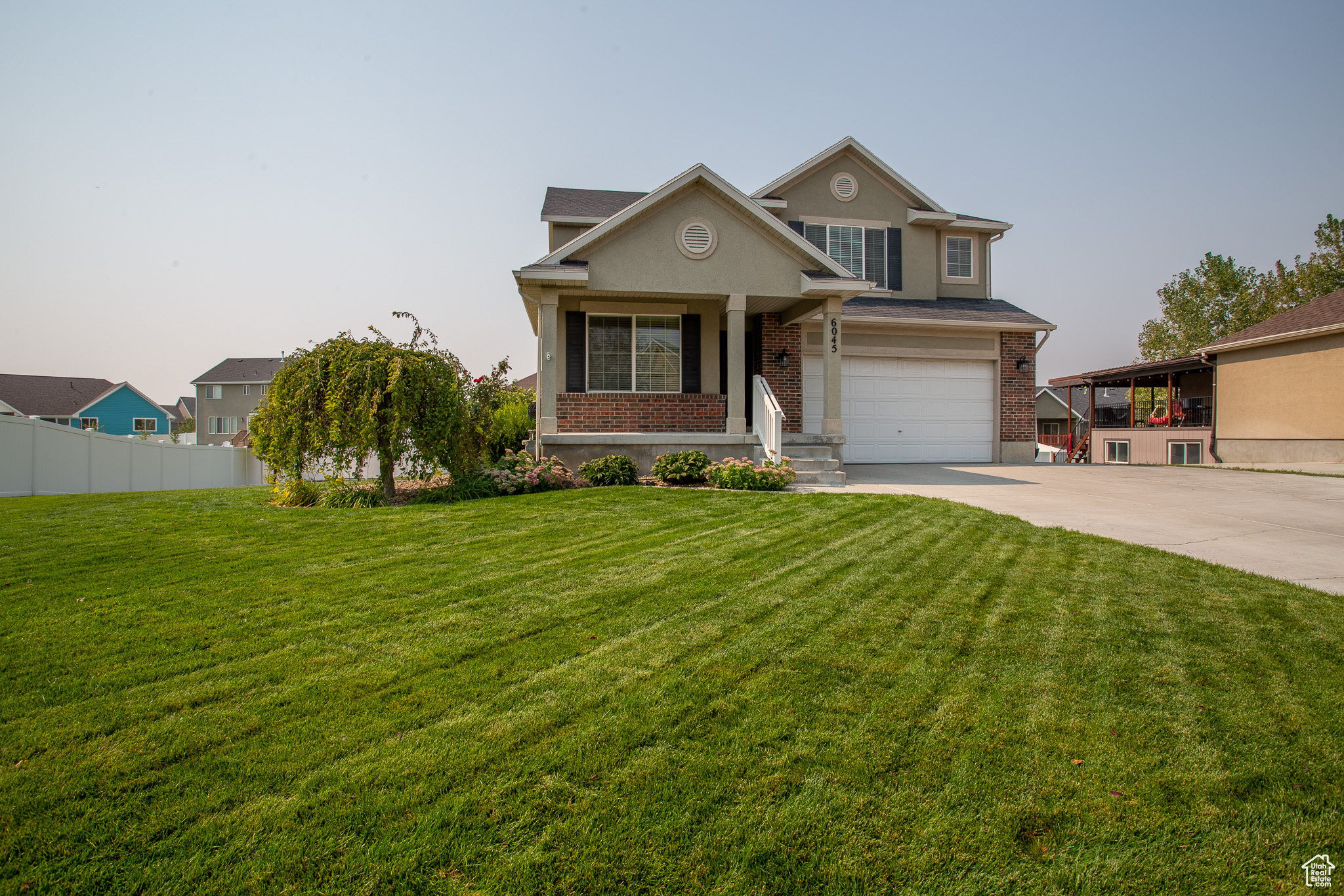 Seller willing to put $5000 toward buyer's rate buyer down, with acceptable offer.  Incredible two-story home in Stansbury! What a great neighborhood! Absolutely beautiful hardwood floor throughout the main floor. Lots of cabinet space in the open and well lit kitchen. Stainless appliances also! The home flows well and feels just right. 4 bedrooms up with 2 full baths. Master having it's own. Bedroom, family room, and cool theater room in the basement. All equipment stays in theater. Basement walks out to a large .26 acre back yard. Detached shed/workshop/garage in back for toys and tools. Area set up for firepit in the opposite corner. Solar panels will be paid off at closing. Keeps your electric bill so that you don't even feel it. Amazing, amazing home!