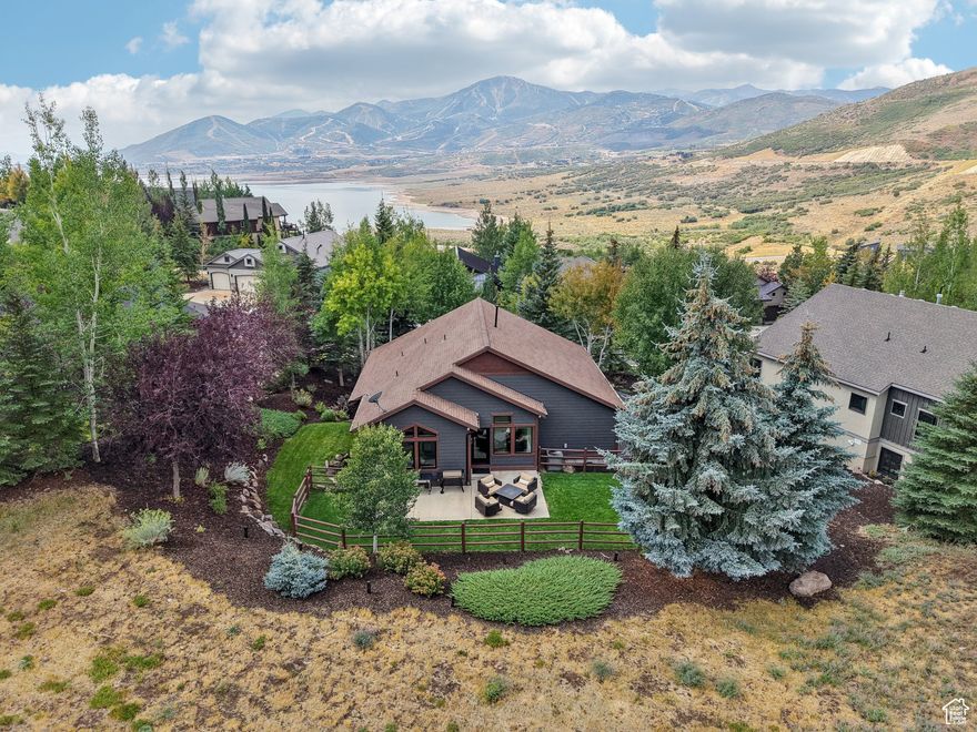 Set on a 0.53-acre lot surrounded by mature trees, this meticulously updated Deer Mountain home is move-in ready. The main level offers a spacious open floor plan with living, dining, and kitchen areas, plus the master suite, laundry room, and an additional bedroom. Step outside to the deck, perfect for summer dining, while taking in mountain, ski run, and lift views. The walk-out lower level provides another gathering space along with two bedrooms, ideal for family or guests. A 3-car garage and low annual HOA dues add convenience and value.  Recent updates include a new roof and gutters, Pella windows and exterior doors, Tesla charger, water heater, humidifier system, and A/C unit. Inside, enjoy remodeled bathrooms, new carpet, appliances, fresh paint, and countertops throughout-every detail has been thoughtfully refreshed.   Located at the Jordanelle Reservoir in Deer Mountain, this home offers quick access to year-round recreation and is only 10 minutes from Kimball Junction, Old Town, Deer Valley East Village, and the Uinta National Forest.