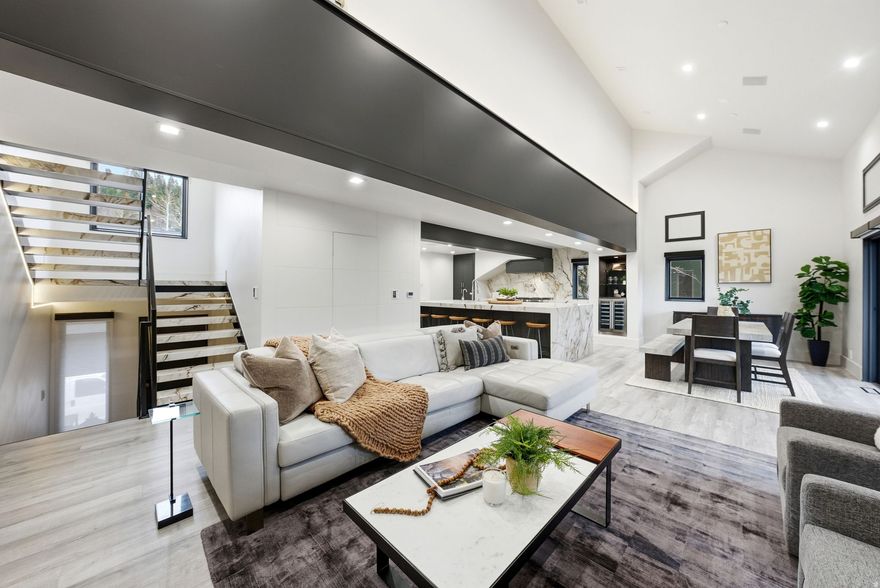 Chic and Stylish 3 Bedroom Lakeside Townhome! One of a kind 3-bedroom Lakeside townhome overlooking the serene Deer Valley ponds. This chic remodeled home is the epitome of style and refinement with highest quality finishes. The gourmet kitchen, with a 13' custom stone island, is an entertainer's dream opening to the dining and great room which boasts a stunning floor to ceiling fireplace. The luxurious, expanded private master suite is your personal retreat offering Deer Valley ski run views. The ensuite bathroom has a wet room with tub and steam shower and TV (!). The lower level offers two additional bedrooms with walkouts to the pristine outdoors, a beautifully designed bathroom, separate laundry and private two car heated garage with built in custom storage. Offered furnished. Too many upgrades to list! Lakeside residents enjoy access to a new heated pool, soothing hot tubs, a rejuvenating sauna, and convenient changing rooms. The door-to-door complimentary skier shuttle to Deer Valley's Snow Park Lodge ensures a seamless alpine experience. Adjacent to Deer Valley's charming Grocery Cafe. With current HOA improvements, Lakeside at Deer Valley is one of the most beautiful complexes in Deer Valley. Easy access to hiking and biking trails and a short walk to Park City's historic Main Street with restaurants and shops