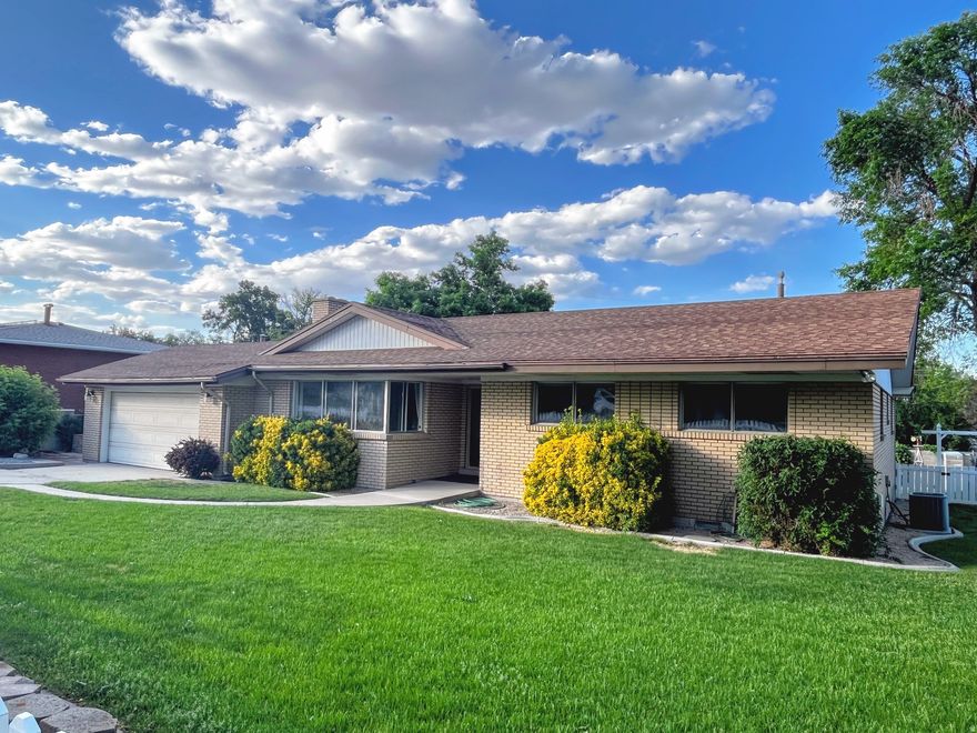 WOW! What a find. Beautiful rambler on a quiet, established street in the heart of Taylorsville - this well-loved brick home offers great bones and outstanding indoor and outdoor living space, perfect for a buyer ready to add their personal touch. Open and spacious family room, large windows with tons of natural light. Beautiful fireplace centers the room. Hardwood floors wait beneath the carpet, and a brand-new furnace (2025) means the big-ticket mechanical work is already done. Step outside and the backyard becomes the star of the show: a large covered deck with string lights, set up for a hot tub, deck overlooks the beautifully landscaped yard that is the perfect set up for year-round entertaining and fun. The home also backs the canal so no rear neighbors, just open sky and mature trees. The yard has a storage shed and has plenty of room for a playset, trampoline, even a fire pit area. Inside, the galley kitchen is loaded with solid oak cabinetry, Corian countertops, a wall oven and microwave, a built-in cooktop, and dishwasher. Two bathrooms serve the three bedrooms comfortably. The attached 2-car garage offers workshop potential and extra storage. Centrally located with quick freeway access to both I-15 and I-215, placing you minutes from shopping, dining, and the entire valley. Come see the potential - this one is ready for new memories. Come and See!