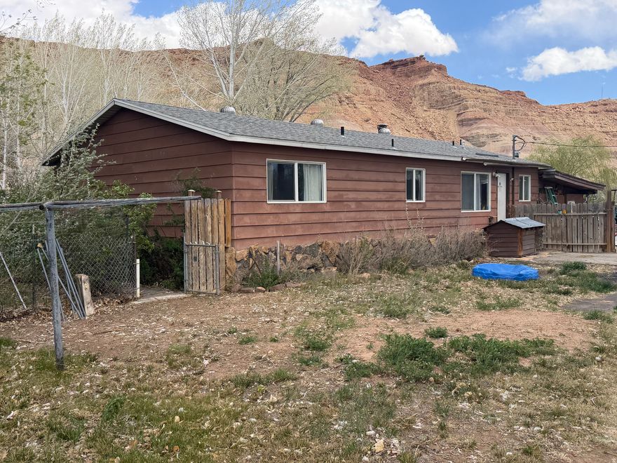 A secluded 3-bed, 1-bath house on wooded acreage with BIA irrigation water. The inside has had several upgrades, including newer windows, LVP flooring, and granite kitchen countertop. The north half of the roof was replaced in April. The land has many mature trees, including various fruit trees, and some pasture ground. There are also numerous outbuildings and a two-car garage. Come see what possibilities there are with this Randlett property.