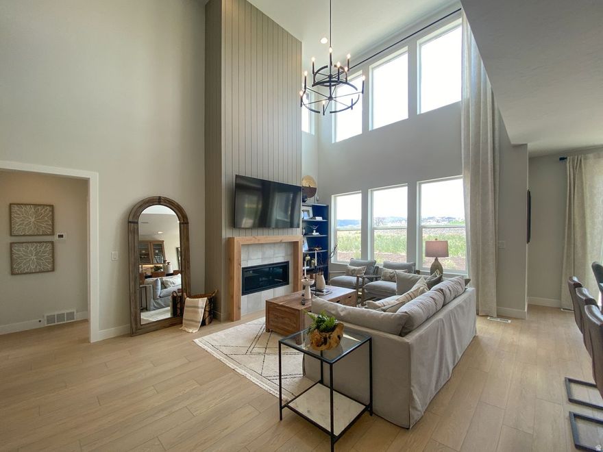 Open House 4/18, 12-4pm, meeting point at Model Home - 917 W Columbia Ct, Riverdale. $50,000 in FREE BASEMENT +PERMANENT RATE AS LOW AS 4.99% THROUGH PREFERRED LENDER*. Limited time offer on select lots through First Colony Mortgage. Subject to market conditions/borrower qualifications. All loans subject to credit and approval.* Completion end of May! $180,000 in upgrades, Main-level living, 3rd car garage + EV charger outlet, 9-ft finished basement, Huge loft on second floor, Soaking tub + separate shower in primary suite, Modern gas fireplace with shiplap surround, Whirlpool gourmet appliances, Countertop stove + soft-close cabinetry, Extended pantry, Smart home system with fiber internet, Mountain view lot, Full surround James Hardie siding, Quartz countertops throughout, Upgraded matching cabinets & countertops in kitchen and bathrooms, Double HVAC systems for efficiency.  Welcome to The Winslow-a standout floorplan offering 5 bedrooms, 4 bathrooms, and 4,105 sq ft of beautifully designed space. From the moment you walk in, the layout feels intentional and elevated. A versatile flex room off the entry sets the tone-perfect for a home office, media lounge, or creative space-paired with a convenient powder room nearby.  The main-level living design is a rare and coveted feature, anchored by a warm, inviting great room with a modern fireplace and shiplap surround. The kitchen delivers both form and function with a statement island, extended cabinetry, a generous pantry, and gourmet Whirlpool appliances-designed for everything from quiet mornings to hosting in style.  Tucked privately on the main level, the primary suite feels like a personal retreat, complete with a spa-inspired bathroom featuring a soaking tub, separate shower, and a spacious walk-in closet.  Upstairs, a massive loft opens up endless possibilities-lounge, workspace, game area-alongside two additional bedrooms and a full bathroom. Downstairs, the finished 9-ft basement expands your options even further with a large recreation space, two bedrooms (including one with an ensuite), a flex room, and ample storage.  Set on a mountain view lot in the highly desirable Riverdale community, this home offers the best of both worlds-peaceful, quiet surroundings with everyday convenience just minutes away. Enjoy quick access to shopping, dining, and freeway connections, all while coming home to a setting that feels relaxed and tucked away.  With its thoughtful layout, elevated finishes, and unbeatable location, this home delivers a lifestyle that feels as good as it looks. *Photos are from other similar floorplans for easy visualization. Will be updated with photos periodically. *Permanent buydown as low as 4.99% (5.273% APR). Limited time offer on select lots through First Colony Mortgage. Subject to market conditions/borrower qualifications. All loans subject to credit and approval.