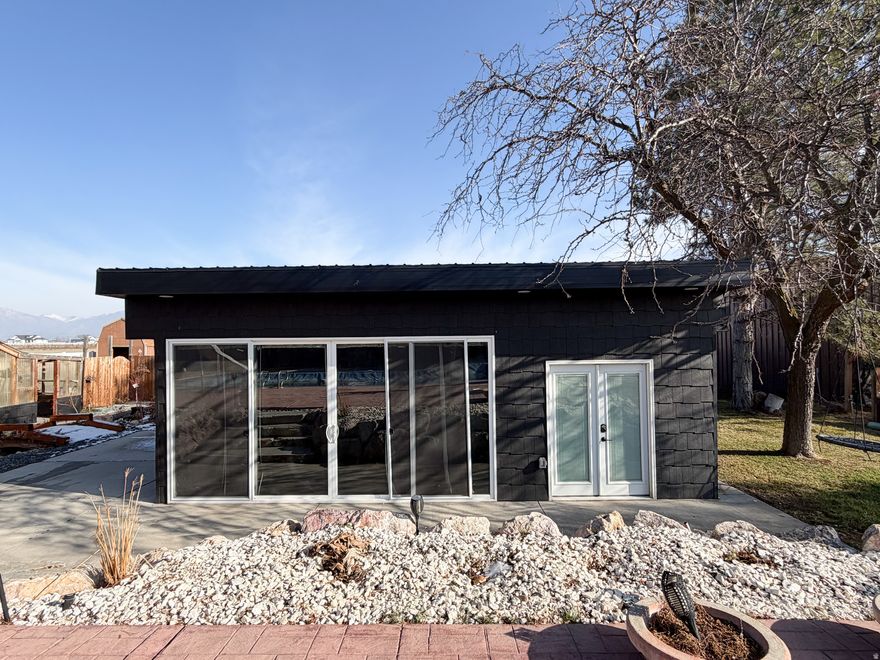 Now Priced at $985,000. Detached studio home (896 sq ft) with immediate income of approximately $1,800/month, ideal for offsetting the mortgage, multigenerational living, or guests, sets this property apart. The detached studio also features a ductless mini-split system for efficient, individual climate control. Situated on a private .93-acre lot at the end of a quiet dead-end road, the property includes a heated 3060 shop with office space, offering exceptional flexibility for vehicles, hobbies, or business use, plus ample additional parking.  The main residence offers 3,100 sq ft, 4 bedrooms, and 4 bathrooms in a versatile multi-level layout with new interior paint and new carpet in the basement family room, along with a newly added three-quarter bathroom. The main home is also equipped with a ductless mini-split heating and cooling system, providing individual room climate control.  Outdoors, enjoy a resort-style backyard with pool, pond, and mature landscaping, creating a private setting ideal for entertaining or relaxing.  A rare opportunity combining income potential, acreage, functional space, and lifestyle - a truly unique offering.