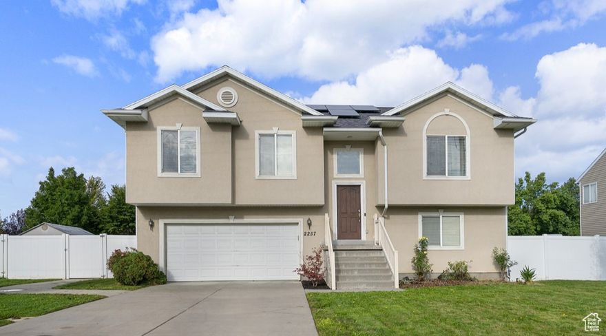 Welcome to this beautiful West Bountiful home. Functional layout with updated kitchen complete with granite countertops & vaulted ceilings. Step outside onto the large Trek deck, perfectly positioned to enjoy Utah's stunning sunset views.  Home features include:  new furnace, new A/C, new water heater, and a new roof with solar panels means you'll enjoy lower utility bills and increased sustainability.  Walk-out basement with great natural light. Large fully fenced backyard, ideal for gatherings, play, or gardening.   Located in a quiet, established neighborhood with convenient access to parks, schools, shopping, and I-15. - schedule your private showing today!