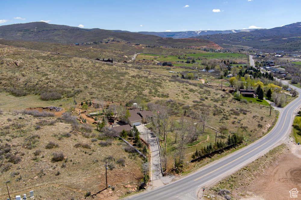 Welcome to your private sanctuary nestled just outside Heber City, offering tranquility and space on nearly 5 acres of versatile land. Whether you choose to keep it as one expansive parcel or potentially subdivide into three, this property provides incredible options for privacy, investment, or future development. Step inside to soaring ceilings and abundant windows that flood the home with natural light. The open-concept layout creates a warm and inviting atmosphere throughout.Two additional bedrooms and a 3/4 bathroom upstairs offer privacy and comfort, with stunning views of Mount Timpanogos. The basement features an open-concept design, a separate entrance suitable for mother-in-law quarters, plumbing for a second kitchen, two bedrooms, and a full bathroom-perfect for multi-generational living or rental opportunities. Enjoy gatherings on the expansive tiered deck lounging space, encircled by beautifully crafted tiered rock retaining walls that enhance the landscape and provide privacy. The outdoor space is perfect for entertaining, relaxing, and enjoying the scenic mountain views and mountain fresh air, including the breathtaking vistas of Mount Timpanogos. This exceptional property combines privacy, space, and flexibility-ready for your personal touch. Don't miss the opportunity to own this secluded oasis with endless potential! Contact us today to schedule a private tour and experience all this remarkable home has to offer! Two water shares with Lake Creek Irrigation. New roof on main home and garage 2023, water heaters December 2024, new furnace & AC 2018. Agent related to seller. Buyer/Buyer's agent to verify all information.