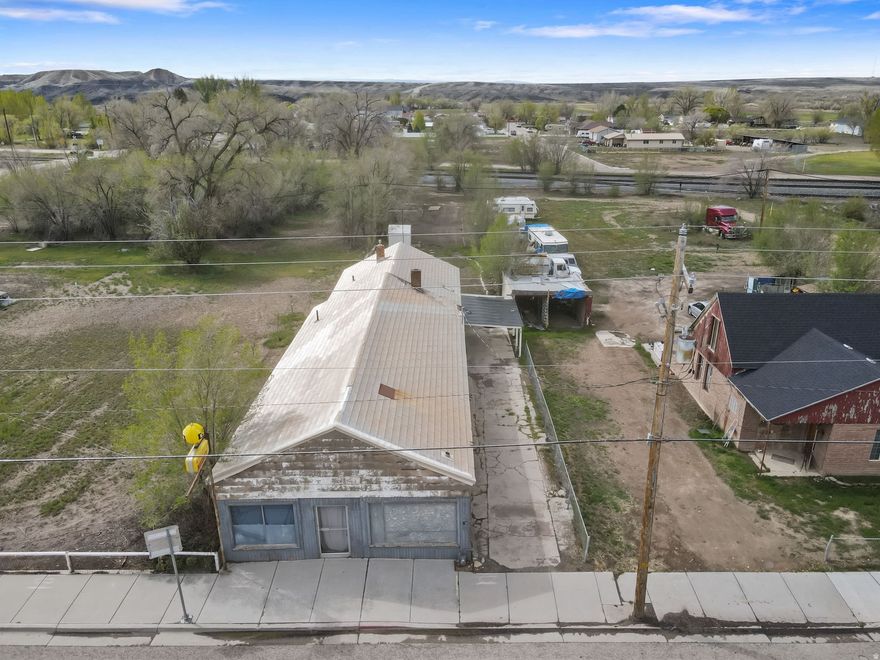 Unlock the potential of this truly unique live/work opportunity in the heart of Wellington! Zoned General Commercial and situated on nearly a third of an acre, this versatile property offers exceptional visibility and access right on Main Street (Highway 6)-the primary route connecting the Wasatch Front to Green River, Moab, and the stunning San Rafael Swell. With a high daily traffic count, this location is ideal for a business looking to capture steady exposure. The property features a 3-bedroom, 1-bath residence paired with an attached storefront space complete with a half bath and ample storage-perfect for retail, office, or service-based use. Whether you're an entrepreneur seeking a convenient live/work setup or an investor looking for income potential, this property delivers flexibility and opportunity. Positioned next door to the well-known local favorite, the Cowboy Caf, and just minutes from shopping, dining, and entertainment, the location combines small-town charm with strategic accessibility. County tax records reflect 1,094 square feet; however, the actual square footage is believed to be more than double. Buyers are advised to verify all measurements. Priced with condition in mind, this property offers tremendous upside. With vision, TLC, and effort, it can once again become a vibrant and valuable part of the community. The true value lies in the land, location, and limitless potential. Don't miss your chance to bring this property back to life and make it your own!