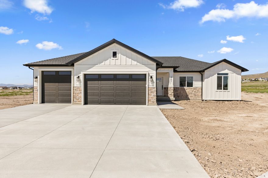 Discover comfort, style, and convenience in this beautiful new construction home located in a quiet, growing neighborhood in Tremonton. Thoughtfully designed with quality finishes and modern touches throughout, this home offers the perfect blend of function and elevated style.  Inside, you'll find upgraded features that truly set it apart, including custom trim work, custom cabinetry, quartz countertops, and stunning ceiling-height tile that adds a high-end feel to the space. Every detail has been carefully selected to create a clean, timeless look you'll love coming home to.  Another standout feature is the extra-deep third-car garage, offering space for a fourth vehicle, toys, additional storage, a workshop, or all your outdoor gear. It's the kind of flexibility today's buyers are looking for.  Enjoy the convenience of being just minutes from everyday amenities, including parks, restaurants, grocery stores, and a nearby golf course. Whether you're running errands, enjoying a night out, or spending time outdoors, everything you need is close by.  If you've been looking for a brand-new home in a peaceful neighborhood with stylish finishes, versatile garage space, and a great location, this one is a must-see.  Square footage figures are provided as a courtesy estimate only and were obtained from the building plans.  Buyer is advised to obtain an independent measurement.