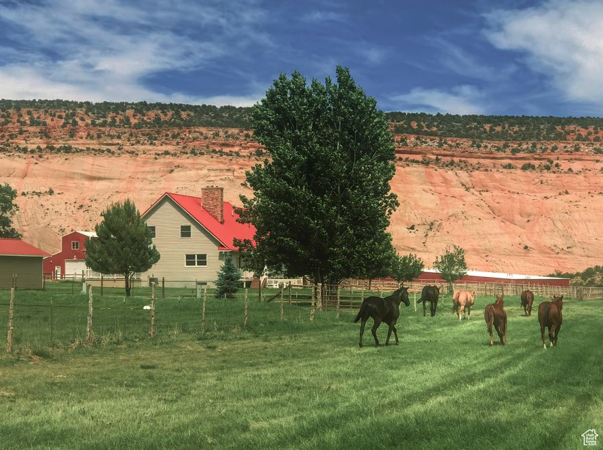 Don't miss out on this exceptional opportunity to own a premier 131+ acre ranch in the heart of scenic Boulder, Utah. Bordering the Grand Staircase Escalante National Monument, these two adjoining parcels offer an ideal combination of peaceful living, ranch functionality, and breathtaking natural beauty. Sugarloaf Valley Farm features a spacious 6-bedroom, 5-bathroom custom home, perfect for large families or entertaining guests. Complementing the main home is a 3-bedroom, 2-bathroom rambler-style ranch house, ideal for extended family or ranch staff. A well-appointed 1-bedroom, 1-bathroom apartment is located above a large barn. The property has been operated as a guest ranch and is turn-key with all furnishings and future reservations if desired.  A standout feature of the property is the massive 70,000 square foot indoor horse arena, offering year-round equestrian use and endless possibilities for events, training, or livestock management. The horse arena has its own living quarters with a full kitchen & living space, two bedrooms & two bathrooms. The property has a pond, hay storage, and beautiful fields with plenty of irrigation and wheel lines, plus an outdoor arena with lighting, a large barn, and outdoor corrals. Whether you're looking for a working ranch, a private retreat, or a multi-family compound with unmatched space, this rare Boulder offering delivers it all in one of Utah's most desirable and serene landscapes, situated between Capitol Reef National Park and Bryce Canyon National Park. Enjoy unobstructed views of Boulder Mountain, sandstone cliffs, and amazing dark skies at night, along with world-class hiking and exploring within minutes of your door. An additional 200+ acres of contiguous land can be available to purchase separately.