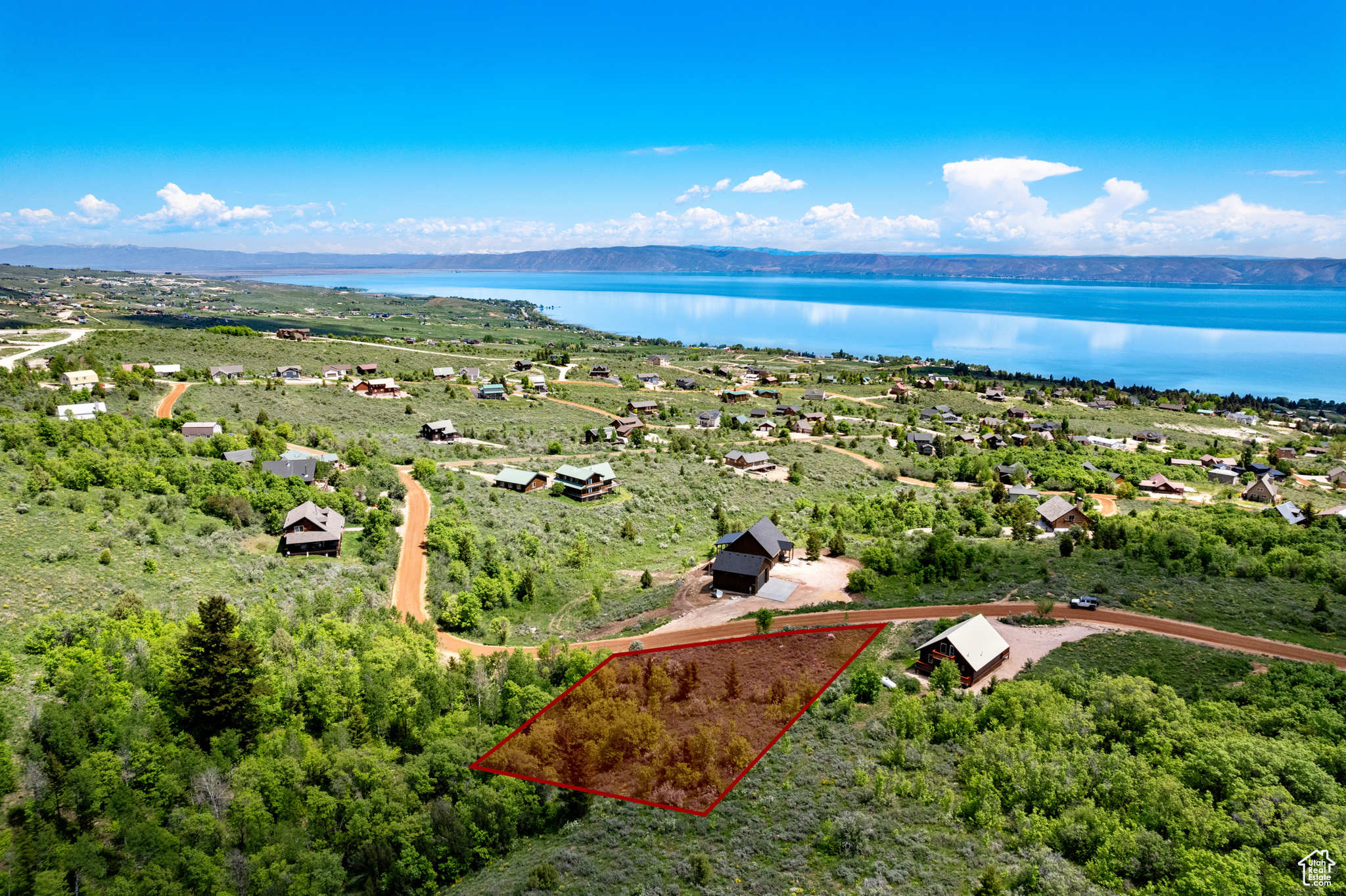 Experience the unmatched beauty of Bear Lake from this exceptional building lot in Bear Lake West. Nestled among quaking aspens and pine trees, this gently sloped lot offers stunning panoramic views of the lake and surrounding mountains. Adjacent to common area on the north and west sides, the property provides added privacy and seamless access to nature. Located in a community that values peace and tranquility, the Bear Lake West HOA does not permit short-term rentals, ensuring a serene and neighborly atmosphere. This is the perfect place to build your dream getaway or full-time residence.