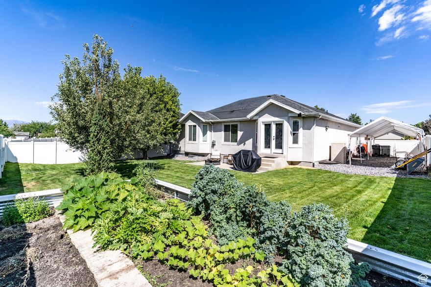 Enjoy the garden-to-table life in American Fork, just steps from Monarch Park and the 40-acre forested butterfly habitat, With $100K+ in upgrades, this peaceful, fully fenced retreat blends spacious living with city convenience. Ask your Realtor for the full upgrade list attached to this listing. Interior highlights include main-level living with the primary suite, 2 secondary bedrooms, laundry, and kitchen all on the main floor. The chef's kitchen features expansive counters, generous cabinets, a new high-end dishwasher, and a professional-grade vented hood. The spa-like primary bath offers a large jetted tub with a dedicated 50-gallon hot water heater. The finished basement includes a great room, workout room, and a removable utility ceiling which is water wise and provides easy access to the insulated ceiling for running additional wiring, maintaining pipes, etc. This home features a newer furnace and AC (4 years), and water heater (2 years). Hardwood floors are lifetime refinishing capable, and exceptional soundproofing keeps upstairs and downstairs spaces quiet and private.  Outdoor features include a fully fenced private yard with mature fruit trees-cherry, peach, nectarine, and apple-plus raised garden beds with premium soil. The garden produces kale, mint, squash, cucumbers, and tomatoes. RV parking is available in a 15'9" x 49'3" side yard which is large enough for a boat, trailer or a 10-ton soil delivery (yes, that has been done!). Recent upgrades include a new graded lawn, reinforced cement walk (2 months old), lifetime-wrapped back door frame, and a durable garden box.  Location perks include being only 10 minutes from Costco, Walmart, Macey's, shopping, and dining. The home is just steps away from a scenic forest trail and city park. It is part of a friendly small-town community known for its nationally ranked marching band and top-rated hospital. Nearby are Art Dye Park, pickle ball courts, the Murdock Trail, American Fork Canyon, Alpine Loop, and Sundance.  Whether you're relaxing in the jetted tub, on the back patio or enjoying nearby trails, this home offers a peaceful lifestyle that will make you glad to be home.