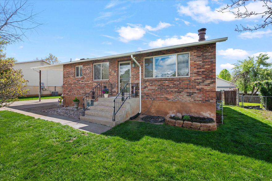 This delightful 4-bedroom, 2-bathroom brick rambler offers an abundance of features perfect for comfortable living and entertaining. Recently upgraded with a beautifully renovated basement, this home provides ample space for everyone's needs. On the main level, enjoy an open floor plan between the living room and kitchen, a full bathroom, and two generously sized bedrooms. Downstairs, discover a large living room, ideal for gatherings, game playing, or movie watching. The basement also features an outside entrance for convenience and privacy. The laundry room offers extensive storage space to keep your home organized. Two additional bedrooms and a bathroom complete the lower level. Enjoy newer kitchen appliances. The refrigerator, washer, and dryer are all included in the sale. Revel in the comfort of new carpet, new storm doors, and some new paint throughout the home. Stay cool in the summer with central A/C and benefit from upgraded windows featuring low-e glass for energy efficiency. Step outside to a lush, green yard with a fenced backyard. The property includes a carport for covered parking plus more space to park an RV or additional vehicles, and two sheds for additional storage. This home is ideally situated just minutes from Layton Hills Mall, I-15 for easy commuting, Hill Air Force Base, and an array of hiking trails. Enjoy the convenience of being only 35 minutes away from world-class ski resorts, downtown Salt Lake City, and the airport. The roof was replaced 4-5 years ago, adding peace of mind for years to come. Don't miss the opportunity to own this charming and well-equipped home in a fantastic location. Schedule a viewing today and envision your new life in this wonderful space! Square footage figures are provided as a courtesy estimate only and were obtained from county records. Buyer is advised to obtain an independent measurement.