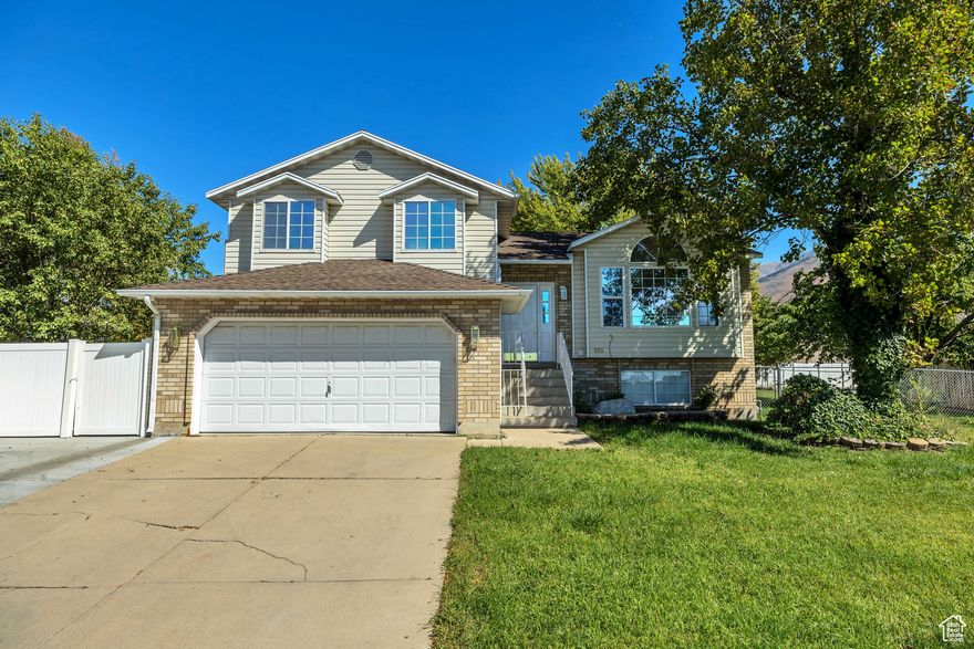 Must See! This beautiful tri-level home in desirable East Kaysville has everything you need to make it your next home. Featuring newer paint and 100% wood flooring on the main levels, this well-cared-for property offers comfort, flexibility, and charm.  A unique highlight is the second kitchen and laundry area, ideal for a mother-in-law suite, future ADU or optional rental income with an independent entrance into a spacious family room.  The large lot is a true retreat with mature apple and cherry trees, a fully fenced backyard, garden space, fire pit, and plenty of room for gatherings. Practical features include RV parking, ample driveway space, a full sprinkler system, and secondary irrigation water ($180/year, March through October).  Conveniently located within walking distance to schools, parks, ponds, and trails. Easy access to HWY 89 and I-15, and just minutes from Lagoon, Cherry Hill, Station Park, and the Frontrunner.  Square footage figures are provided as a courtesy estimate only. Buyer is advised to obtain an independent measurement.