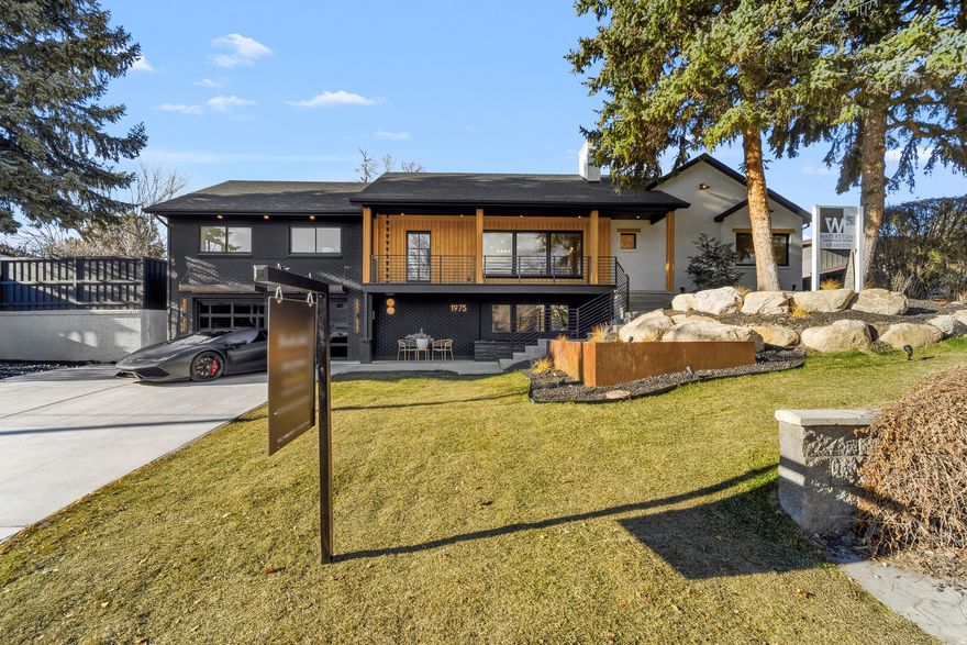 PLEASE ALLOW 4 HRS NOTICE FOR SHOWINGS.  Sometimes a remodel just seems to come together so well that you would think it was the original design.  Such as the case of this beautiful remodel in the heart of Holladay.  Upon entry you'll immediately feel something different, something unique, a beautiful blend of the present with homage to the past with the exposed terra-cotta brick that was intentionally blended into the remodel design from the luxury remodeling team at Waterstone.  The expansive dining area is intentionally placed adjacent to the open kitchen.  The gourmet kitchen features a 6 burner cooktop with minimalistic designed that is then complimented with a butler's pantry offering another sink and refrigerator and leads out to the outdoor cooking area complete with gas hookup for a future grilling station.  From the main living area, guests are treated with an assortment of beautiful spaces that are within the line of sight that lures you in from room to room.  Upon venturing into the next rooms, which are the family room and guest suite area, you can't help but notice the well planned guest suite and bath, the artistic chandelier hanging above the wood staircase, the restaurant style wine room and the private office.  But, once again, from this room, you are teased with the senses of the next space by a wall of folding glass which allows the indoor to flow seamlessly to the outdoor where a gas fire pit awaits with built in seating.  From here you can also see the inviting covered gazebo with 2 chandeliers swinging in the breeze to the right and a professionally installed putting green to the left.  Around the corner is a large tree positioned perfectly amid the spacious grass area.  Stepping down the family room staircase, you are greeted with a custom wood wall slat paneled movie area that invites you into the home gym with floor to ceiling mirrors, an adjacent safe room and designer half bath.  Venturing back upstairs and to the left of the main entrance, you see the full bath in the hall that serves the 2 bedrooms in front of the home.  A second staircase leads downstairs where access to the garage is lined with a slatted bench in the mudroom.  Another guest suite on this level and on this side of the basement features a spacious walk-in closet and grand bathroom making it ideal for family or guests wishing to reside on the garage level living.   Saving the best for last, the crown jewel of the home.  The double doors on the main floor begs to be opened to reveal something truly special.  This is where the original home was dramatically expanded to add one of the most luxurious primary suites on the market.  A five foot walkway that is reminiscent of a luxury suite in an upscale luxury hotel leads you to your primary suite.  To the left is a closet that leaves you breathless with room for a folding table or private massage table and hookups for a stackable washer and dryer setup.  The dramatic vaults separates the primary suite into two areas, the bed to the left and a large siting area to the right that is highlighted by a gas fireplace.  Two doors, one on each side of the fireplace lead to the back yard oasis.  The open bathroom is divided by walnut wood slats that gives the open yet private separation of space.  A massive counter top / vanity spans the entire back wall.  To the left is one of the most unique water rooms complete with 2 skylights, once again, bringing the outdoor in.  A private water closet and hotel style coffee bar area completes this luxury ensuite.