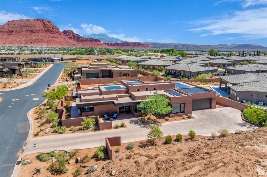 Nestled in the prestigious Indigo Trails community, this stunning custom home boasts breathtaking views of the majestic Red Mountains. Quality attention to detail throughout. Inside you will find an expansive open living room designed to maximize the mountain views, with large windows and a cozy fireplace. The chef's kitchen is a culinary dream that includes a large island, high end appliances, custom cabinetry and quartz countertops. A convenient casita its own inside/outside entrance that also features its own kitchenette, bath and laundry room. Ideal for multigenerational living. Additional highlights include a dedicated office and spacious game room for entertaining. The backyard is a tranquil desert oasis, complete with a private pool & spa, large patio area and easy maintenance landscaping