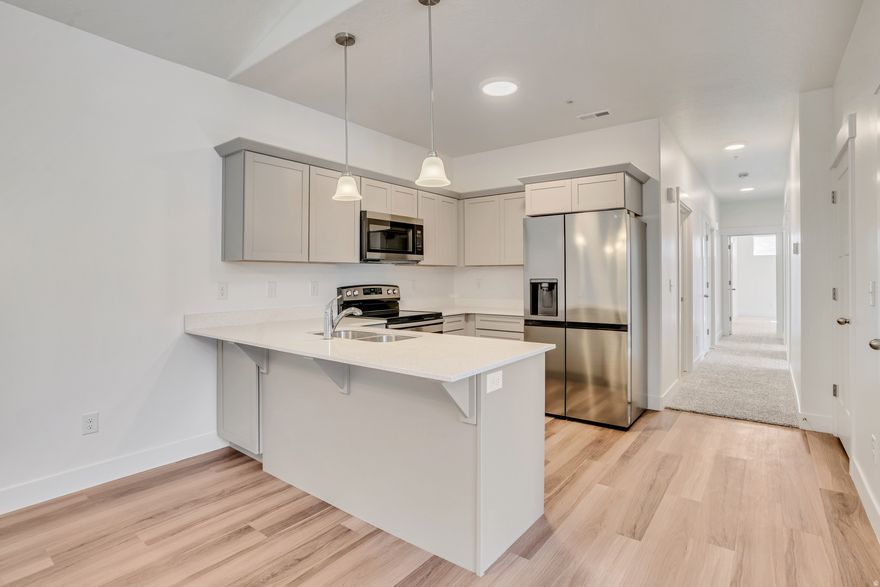 Welcome to North Point - one of Lehi's most sought-after communities, where everyday comfort meets exceptional convenience. This beautifully appointed condominium offers a refined lifestyle in a location that simply can't be beat.  Step inside and enjoy a thoughtfully designed floor plan built for modern living. Your privated garage provides secure, direct-access parking - no scraping windshields on winter mornings. Whether you're hosting friends or enjoying a quiet evening, this home delivers.  Outside your door, the North Point Clubhouse and community pool await - perfect for summer afternoons, weekend relaxation, or connecting with neighbors in a welcoming environment. The community is ideally positioned just minutes from premier shopping centers, top-rated schools, and everyday conveniences, putting everything you need within easy reach.  Commuters will appreciate being just 57 minutes from I-15, offering effortless access to the entire Wasatch Front - from Lehi's booming tech corridor to Salt Lake City and Provo. This is Utah Valley living at its most connected.