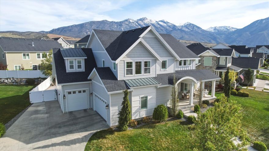 Welcome to your dream home in the coveted Skye Estates community with amazing 180 views of the lake and mountains! This beautifully appointed 6-bedroom, 3.5-bath home offers an open and inviting floor plan designed for both everyday living and entertaining. The generous great room features a cozy fireplace with built-in cabinetry and flows seamlessly into the gourmet kitchen, complete with double ovens, a gas range, quartz countertops, and a large walk-in pantry. Soaring nine-foot ceilings, extra-wide stairways and hallways, hardwood floors, and abundant natural light enhance the home's spacious feel throughout. Upstairs, you'll find four large bedrooms, a generously sized loft perfect for a playroom or second family room, a spacious laundry room with built-in cabinetry, and a convenient Jack-and-Jill bathroom. The luxurious primary suite features a large walk-in closet and a spa-like bathroom with dual sinks, a soaking tub, and a separate shower. The finished basement offers incredible versatility with a private guest suite with access to a full bathroom, an additional bedroom, a large family room, a fun under-the-stairs play space, and a massive cold storage room with built-in shelving. A three-car garage provides ample room for vehicles and additional storage. Step outside to enjoy fun-filled days on your private backyard pickleball/sport court, or relax on the wraparound front porch while taking in stunning mountain and lake views at sunset. The  home is ideally located directly across from the neighborhood park, featuring a playground, picnic area, and walking path. Skye Estates boasts exceptional community amenities, including a pool, gym, and clubhouse with a private theater available for events. With easy access to shopping, dining, and top-rated schools, this home offers the perfect combination of space, luxury, and location. A truly rare opportunity-don't miss it! Square footage figures are provided as a courtesy estimate only and were obtained from previous MLS listing. Buyer is advised to obtain an independent measurement.
