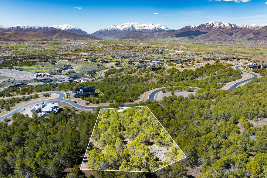 Few remaining homesites in Red Ledges feature Mount Timpanogos front and center the way this one does. Panoramic views stretch across the entire Heber Valley, framed by the Uinta Mountains to the south, the Wasatch Range to the west, and Deer Valley to the north. If you're looking for big views, this delivers. At 2.35 acres, the build envelope sits above the road, giving future architecture a natural elevation that helps protect those views long-term. The driveway is already cut in, reducing construction costs and complexity from the start. Build a custom home, or explore thoughtfully designed semi-custom floor plans through the Red Ledges Construction Artisan Home Building Program. All membership categories are available, offering access to two Jack Nicklaus Signature Golf Courses, tennis and pickleball, a fitness and wellness center, equestrian facilities, two pools, and miles of trails; supporting a true four-season lifestyle.