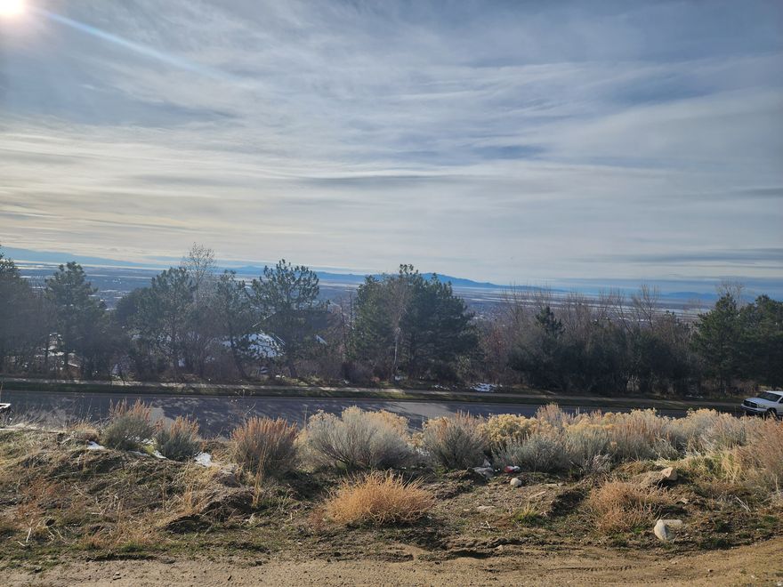 0.32-acre (13,940 SF) recorded subdivision lot on Bountiful's highly desirable east bench, located near the Bountiful Temple. This exceptional homesite offers remarkable valley and mountain views with an elevated setting that captures the beauty of the surrounding landscape. The lot's grade profile is well suited for a custom home design featuring a walk-out basement, drive-out garage, or lower-level access - creating excellent flexibility for layout, living space, and garage configuration. A rare opportunity to build a custom residence in an established subdivision with strong curb appeal and scenic surroundings. Utilities stubbed and ready for your custom build.