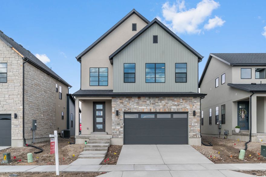 Beautiful brand new Sonderborg-a thoughtfully designed home offering modern finishes and energy-efficient features throughout. The stylish kitchen features gray laminate cabinetry, sleek quartz countertops, a tile backsplash, and platinum gas appliances-perfectly blending function and contemporary design. A gorgeous combination of laminate hardwood, tile, and plush carpet flooring flows throughout the home, complemented by elegant two-tone paint and abundant can lighting for a bright, welcoming feel. The metal railing at the stairway adds a striking architectural touch. The great room is anchored by a cozy gas log fireplace, creating an inviting space for gathering and relaxing. The owner's suite includes cultured marble shower surrounds and black matte hardware for a clean, polished finish. Additional highlights include a tankless water heater, Christmas light outlets for easy seasonal decorating, and energy-efficient options designed for comfort and long-term savings. A well-appointed home that perfectly balances style, comfort, and efficiency.