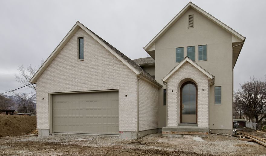 Brand New 5 Lot subdivision! This listing and price is for the nearly complete home on Lot 4 combined with the extra acreage of Lot 5 to create an estate home on a .24 acre lot.  This extra lot addition gives the lucky homeowner plenty of space to dream up a large side yard oasis, garage addition, ADU,  or whatever else you can imagine and Millcreek City will approve. You'll also preserve coveted views of Mount Olympus and enjoy extra privacy.  Located in the heart of Millcreek . . . an area loved by generations for being central to downtown life and mountain adventures alike. This lux cottage two-story is designed to be both cozy and spacious, modern and classy, all while reflecting the timeless architectural charm of the area. Classic brick exterior accents, custom arched front door, and arched built-in's give this home a modern cottage vibe. Includes 9ft ceilings on the main and in the 100% finished basement with separate entrance. Call for more details and to secure this one-of-a-kind masterpiece homes now with extra acreage. Estimated completion on the home is end of March 2026