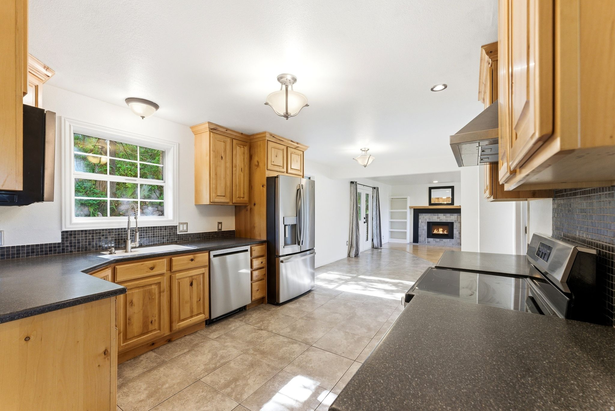 Kitchen featuring Alder wood cabinetry, stainless steel appliances, solid surface countertops
