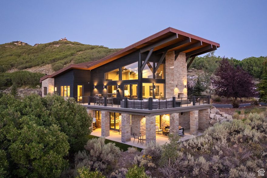 Experience refined mountain living in the heart of Promontory. This contemporary masterpiece blends striking architecture with warm, livable design, framed by panoramic views of Utah's rolling hills. Expansive windows flood the open-concept living spaces with natural light, highlighting soaring ceilings, custom finishes, and artful details at every turn. The chef's kitchen, with sleek cabinetry and a waterfall island, flows seamlessly into the great room-perfect for hosting intimate gatherings or aprs-ski evenings.  Curated interiors include a sophisticated home office, a serene primary suite with spa-inspired bath, and thoughtfully designed guest spaces. Outdoor living takes center stage with multiple patios that invite you to soak in golden sunsets and crisp mountain air. Situated moments from Promontory's world-class amenities-golf, dining, spa, and endless recreation-this home offers the perfect blend of elegance, comfort, and convenience.  Live where luxury meets lifestyle. Welcome home.